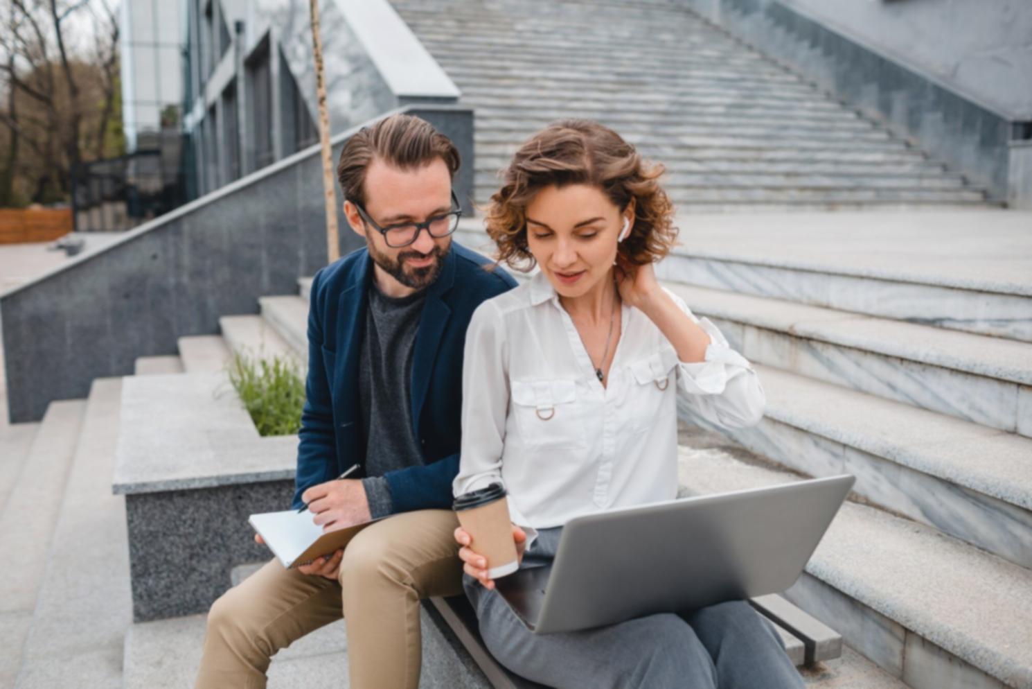 Student team collaborating on startup fundraising pitch deck with financial projections